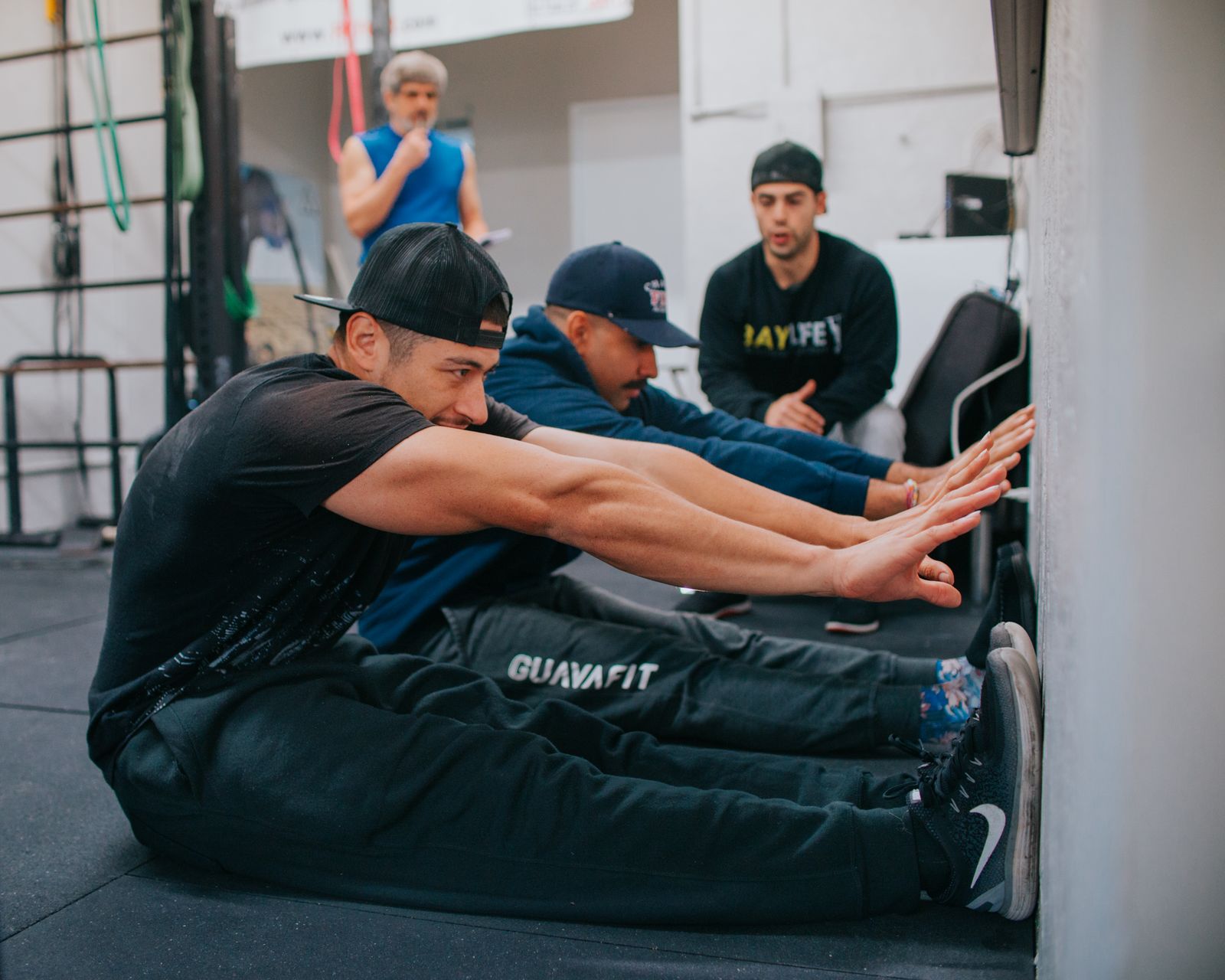 Two men working through a floor mobility exercise