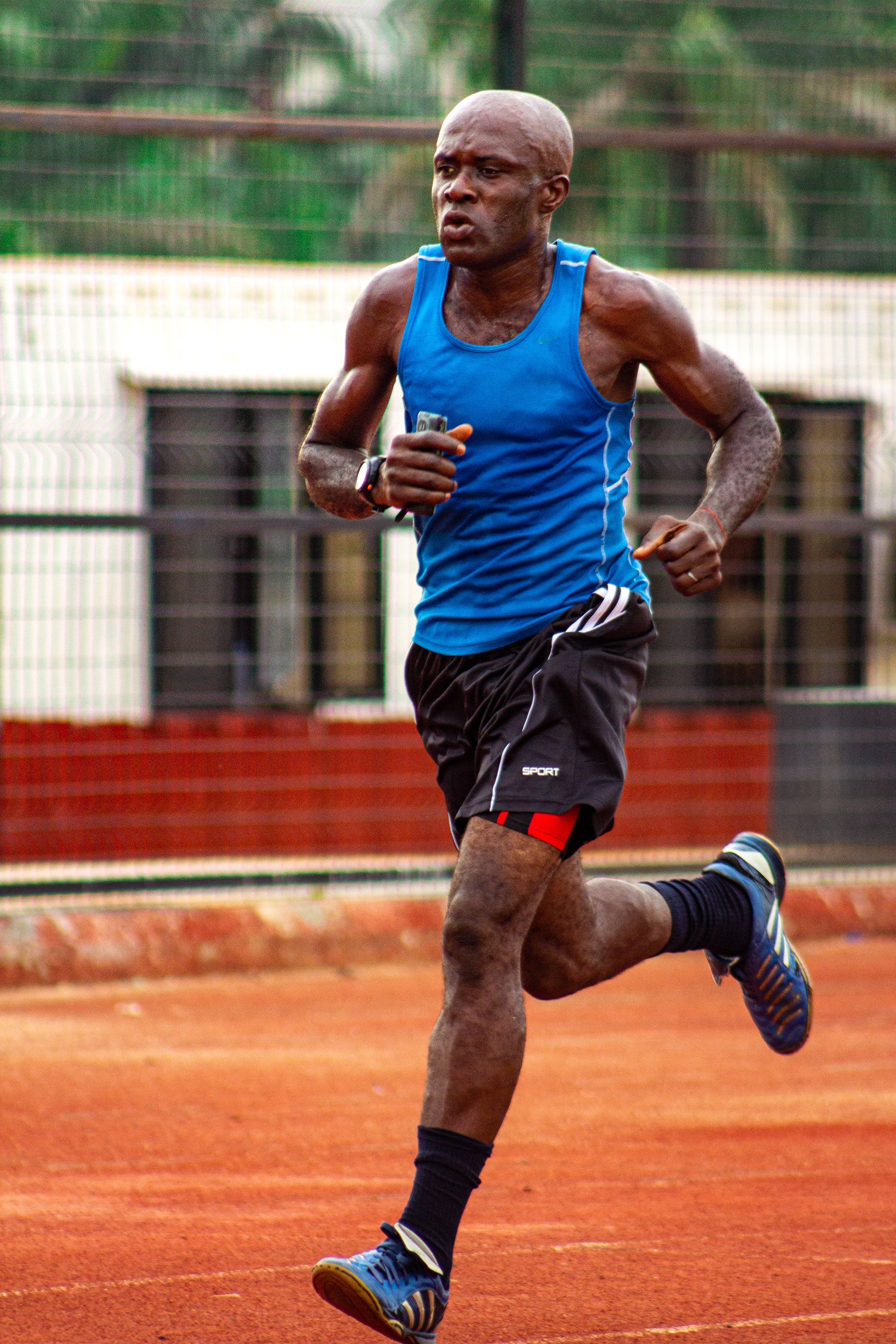 Runner training at a measured pace on an outdoor track